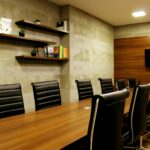 Home Elegant boardroom with leather chairs and wooden decor, ideal for meetings.